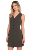 A woman modeling a sleeveless V-neck mini dress in dark olive green with a front button placket, photographed against a plain light beige studio background.