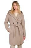 Woman wearing a beige coat with a hood on a plain background